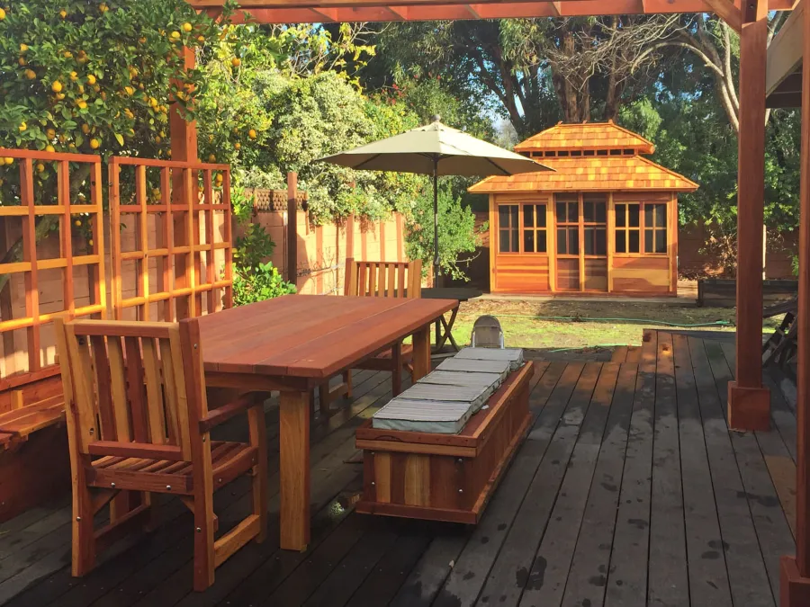 Dream Gazebos (Options: 7ft Wall Height, 12' L, 10' W, California Redwood, All Sliding Windows with Screens, 4' x 4' Skylight, 30" H Siding Below Windows, Horizontal Siding, Japanese Doors, Complete Floor, Set of Shingles, Transparent Premium Sealant). Photo also shows a San Francisco Patio Table with 2 Ruth Chairs, a Storage Bench and Mendocino Planters with Trellises. Photo Courtesy of Tina Phi of Palo Alto, CA. 