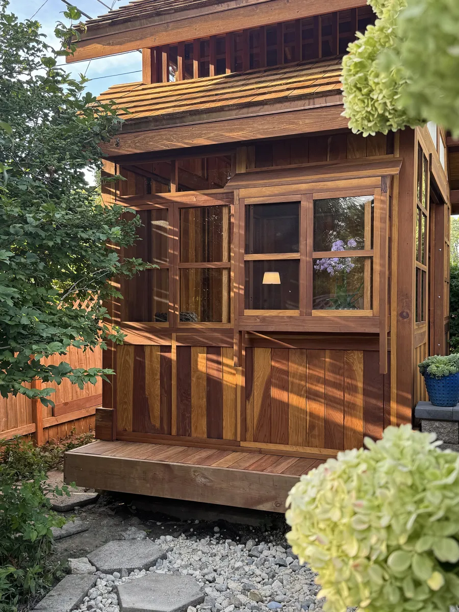 Custom Dream Gazebos (Options: 9 ft Wall Height, 10' L, 14' W, California Redwood, Combination of Sliding Windows with Screens and Fixed Windows, No Skylight, 36" H Siding Below Windows, Vertical Siding, Roof Pitch 8:12, Japanese Doors with Screens, No Floor [Installed on an Existing Deck], Shiplap Roof, Transparent Premium Sealant). Photo Courtesy of J. & R. Griess of Omaha, NE.
