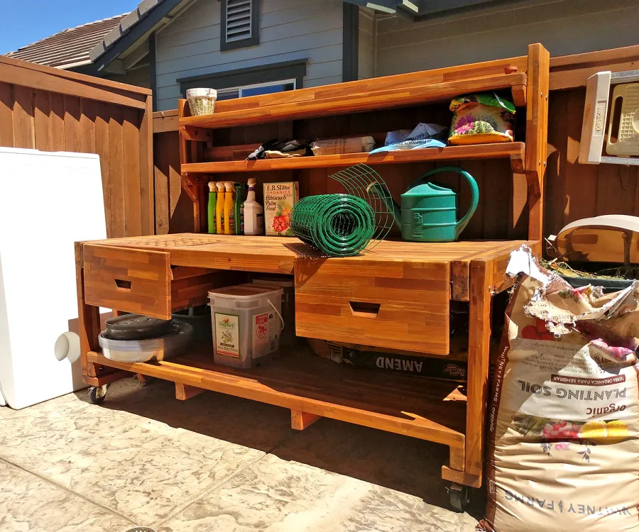 Eli's Redwood Potting Bench (Options: XXL Size, Mosaic Redwood, With Casters, No Fold Down Sides, No Cooper Inset, With Two Shelves, Removable Slatted Lid Over Left Drawer, Transparent Premium Sealant). Photo Courtesy of N. Cabaud of Brentwood, California.