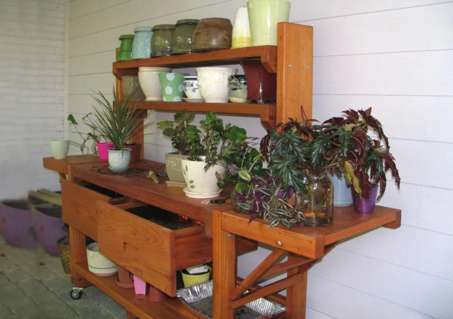 Eli's Redwood Potting Bench (Options: XL Size, Mature Redwood, Casters, 2 Shelves, Both Sides Fold Down, Copper Inset for Both Drawers, No Engraving, Removable Slatted Lid Over Left Drawer, Transparent Premium Sealant). Photo Courtesy of Leslie Hanna of Reston, Virginia.