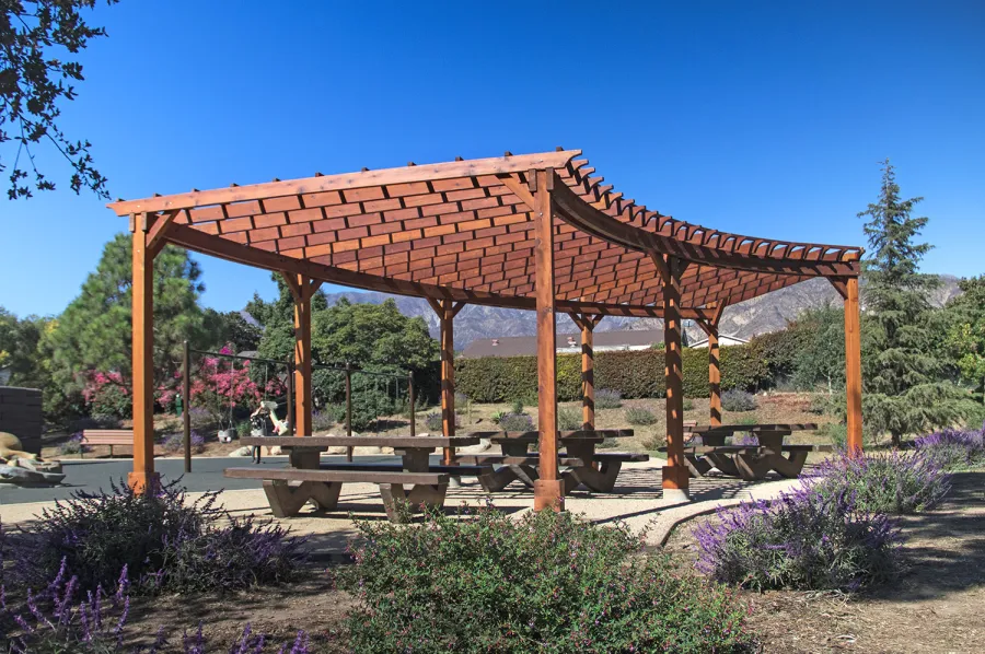 Fan Shaped Pergola Kit (Options: 35' x 16', Mature Redwood, With Roof Slats, No Electrical Wiring Trim Kit, 8-Post Anchor Kit for Concrete, No Ceiling Fan Base, 9.5' Posts, No Curtain Rods, Transparent Premium Sealant). Photo Courtesy of M. Roberts of Carpinteria, California.