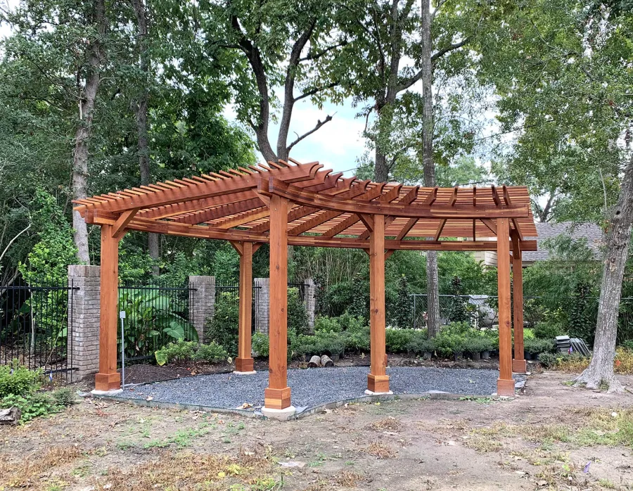 Fan Shaped Pergola Kit (Options: 28' x 12', California Redwood, With Roof Slats at 6", No Electrical Wiring Trim Kit, 7-Post Anchor Kit for Concrete, No Ceiling Fan Base, 9' Posts, No Curtain Rods, Transparent Premium Sealant). Photo Courtesy of Areté Landscape Design @ B. Pfeffer in Houston, TX.