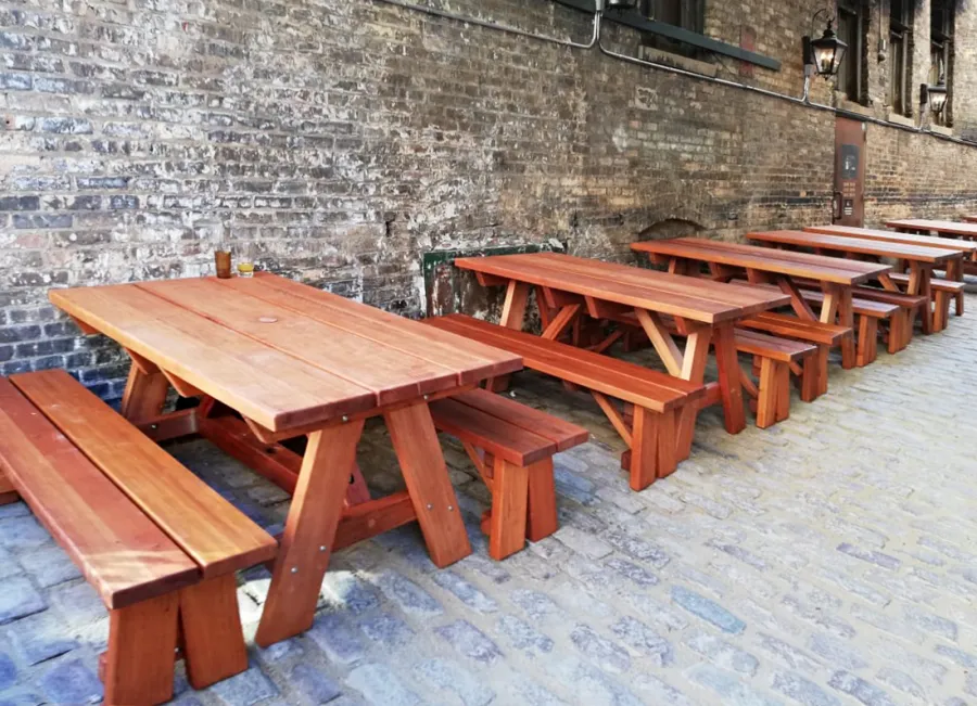 Custom Forever Picnic Tables (Unattached Benches) (Options: 5' L, 34 ½in W, Old-Growth Redwood, 1 Full Length Bench Per Side, Custom Tabletop (with the Book End Work to Make 2 Boards Look Like One 11 ½in Wide Board), Square Corners, 2in Umbrella Hole, Table with an Extra Brace Underneath to Hold the Umbrella Stand, Transparent Premium). Photo Courtesy of A. Koval of Chicago, Illinois.