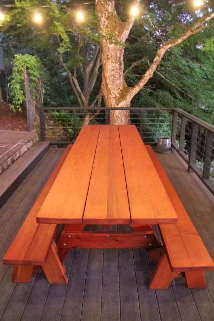 Custom Forever Picnic Tables (Unattached Benches) (Options: 10' L, 34 ½in W, Mature Redwood, 1 Full Length Bench Per Side, Standard Tabletop, Slightly Rounded Corners, No Umbrella Hole, Transparent Premium). Using Two Tongue & Groove Matching 5 3/4" Boards to Create the Appearance of an 11 1/2" Wide Board Construction. Photo courtesy of E. Johnson of Eugene, Oregon.