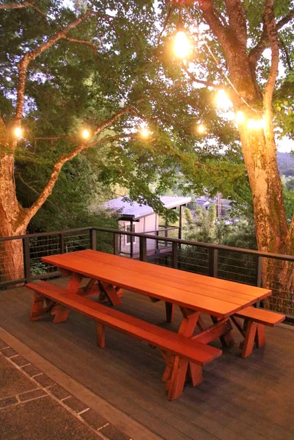 Custom Forever Picnic Tables (Unattached Benches) (Options: 10' L, 34 ½in W, Mature Redwood, 1 Full Length Bench Per Side, Standard Tabletop, Slightly Rounded Corners, No Umbrella Hole, Transparent Premium). Using Two Tongue & Groove Matching 5 3/4" Boards to Create the Appearance of an 11 1/2" Wide Board Construction. Photo courtesy of E. Johnson of Eugene, Oregon.