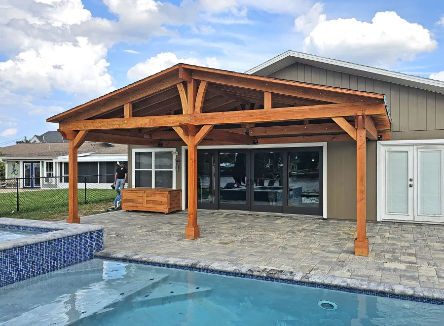 Forever Porch Pavilion (Options: 12' L x 25' W, Douglas-fir, 3-Post Anchor Kit for High-Wind, Electrical Wiring Trim for All Posts, 9 ft Posts Height, 2 Fascia Boards, No Post Decorative Trims, 2 Ceiling Fan Bases, No Curtain Rods, No Privacy Panels, Transparent Premium Sealant). Photo Courtesy of B. Carman of Ormond Beach, FL.