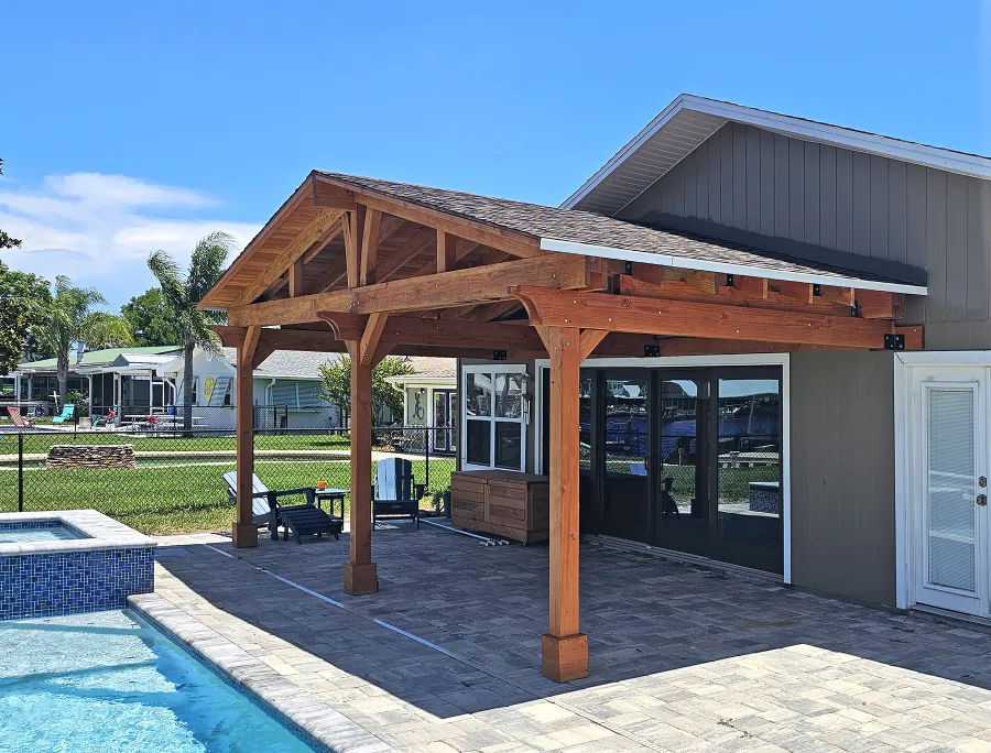 Forever Porch Pavilion (Options: 12' L x 25' W, Douglas-fir, 3-Post Anchor Kit for High-Wind, Electrical Wiring Trim for All Posts, 9 ft Posts Height, 2 Fascia Boards, No Post Decorative Trims, 2 Ceiling Fan Bases, No Curtain Rods, No Privacy Panels, Transparent Premium Sealant). Photo Courtesy of B. Carman of Ormond Beach, FL.