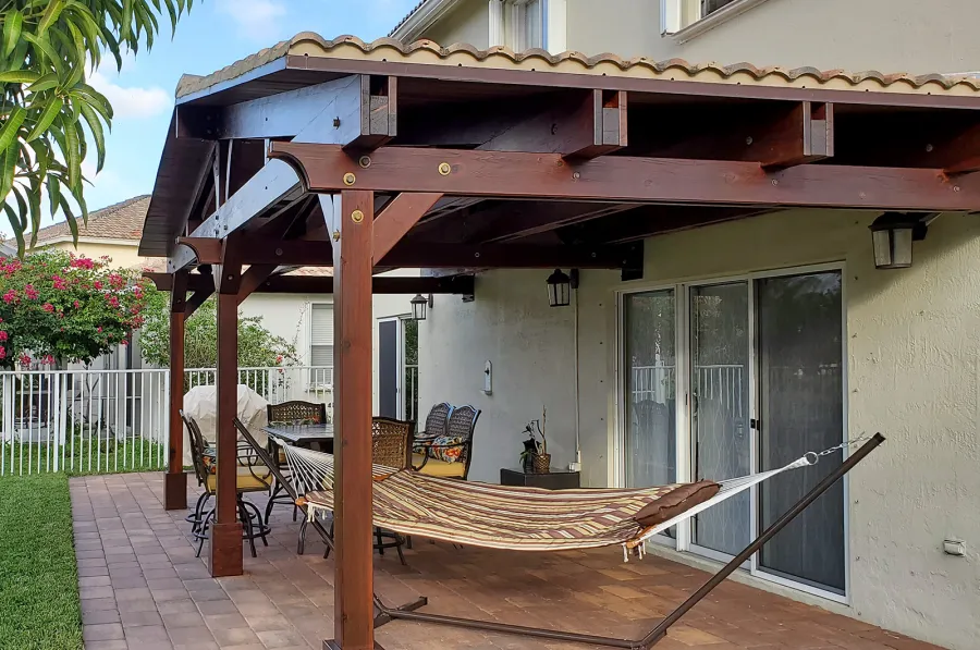 Forever Porch Pavilion (Options: 12' L x 25' W, California Redwood, 3-Post Anchor Kit for High-Wind, No Electrical Wiring Trim, 9ft Posts Height, No Ceiling Fan Base, No Curtain Rods, No Privacy Panels, Transparent Premium Sealant). Photo Courtesy of Carol Varela of Florida.