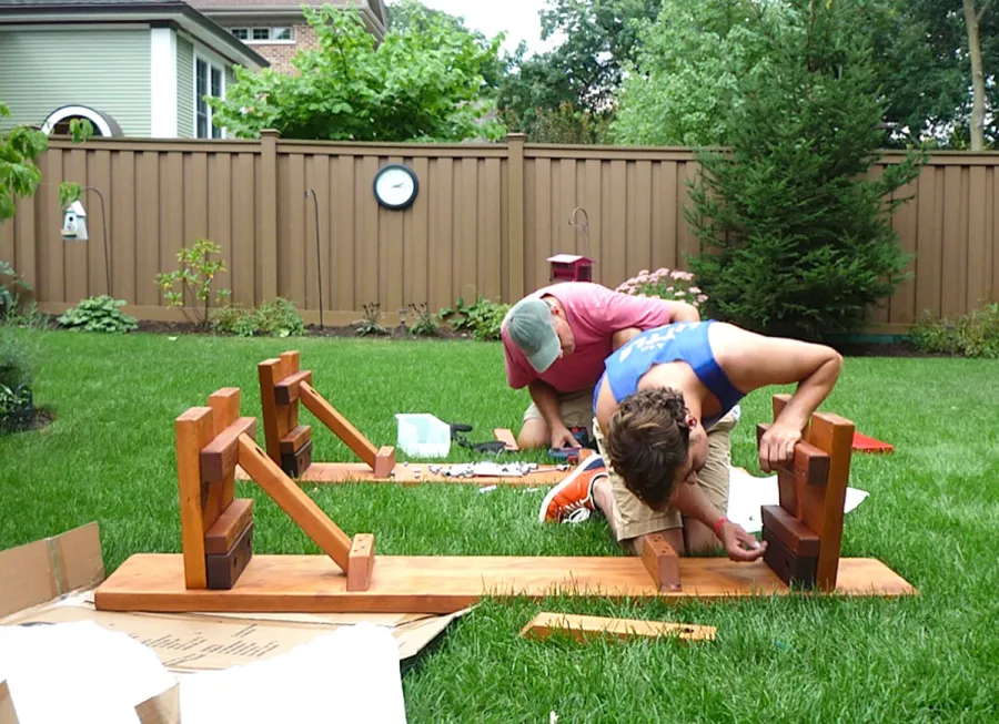 Assembly of a Heritage Large Wooden Picnic Table (Options: 12' L, 34 1/2" W, Side Benches, 2 Half Length Side Benches/Side, Classic Forever Benches, Standard Tabletop, Slightly Rounded Corners, Standard Leg Flair, No Umbrella Hole, Transparent Premium Sealant). Photo Courtesy of Pat Meyer of River Forest, Illinois.