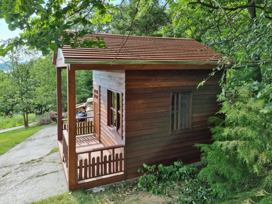 Kid's Backyard Cabin (Options: 14ft L x 10ft W, 8ft Wall H, Douglas-fir [Exterior Siding & Roofing in California Redwood by Custom Request], 4ft Front Porch Size [Included in the Overall Length], Interior Tongue & Groove Flooring, Shiplap Roof, Coffee-Stain Premium Sealant). Photo Courtesy of T. ONeill of Kimberling City, MO.