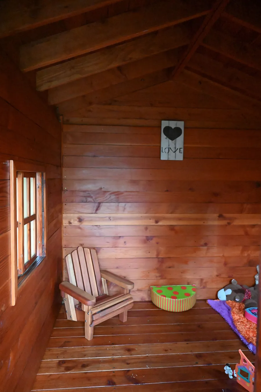 Kid's Backyard Cabin (Options: 12ft L x 8ft W, 7ft Wall H, Douglas-Fir, 4ft Front Porch Size [Included in the Overall Length], Interior Decking, Transparent Premium Sealant). Photo shows structure recently resealed after 6 years of loving service.
