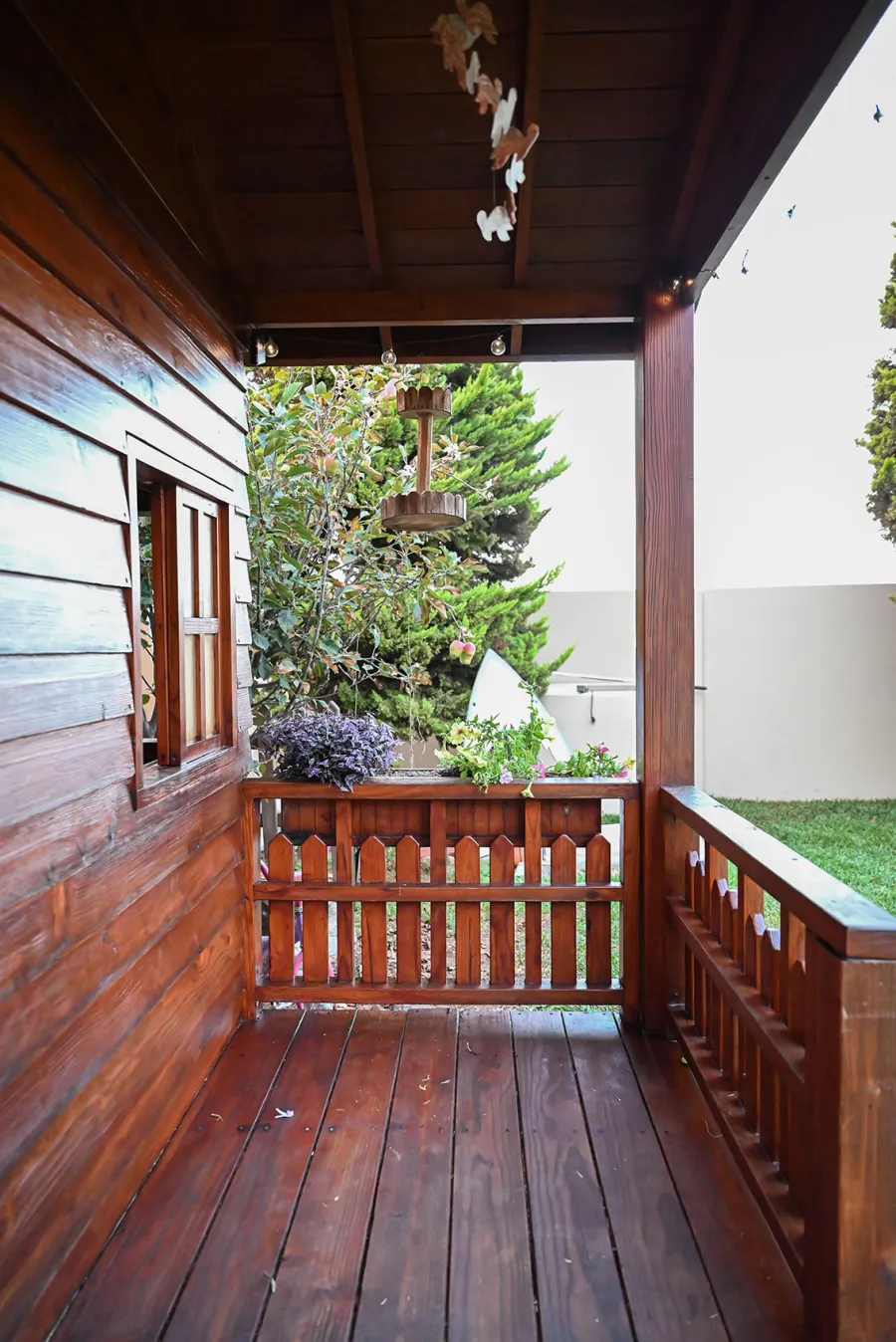 Kid's Backyard Cabin (Options: 12ft L x 8ft W, 7ft Wall H, Douglas-Fir, 4ft Front Porch Size [Included in the Overall Length], Interior Decking, Transparent Premium Sealant). Photo shows structure recently resealed after 6 years of loving service.