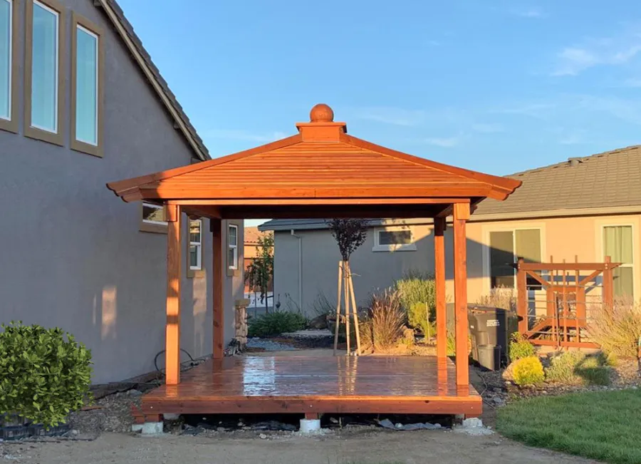 Kikue's Pavilion (Options: 12 ft L x 10 ft W, Standard Wood Roof, California Redwood, No Electrical Wiring Trim, with Floor by Custom Request, 4-Post Anchor Kit for Concrete, Transparent Premium Sealant). Photo Courtesy of R. Cooper of Rio Vista, California.