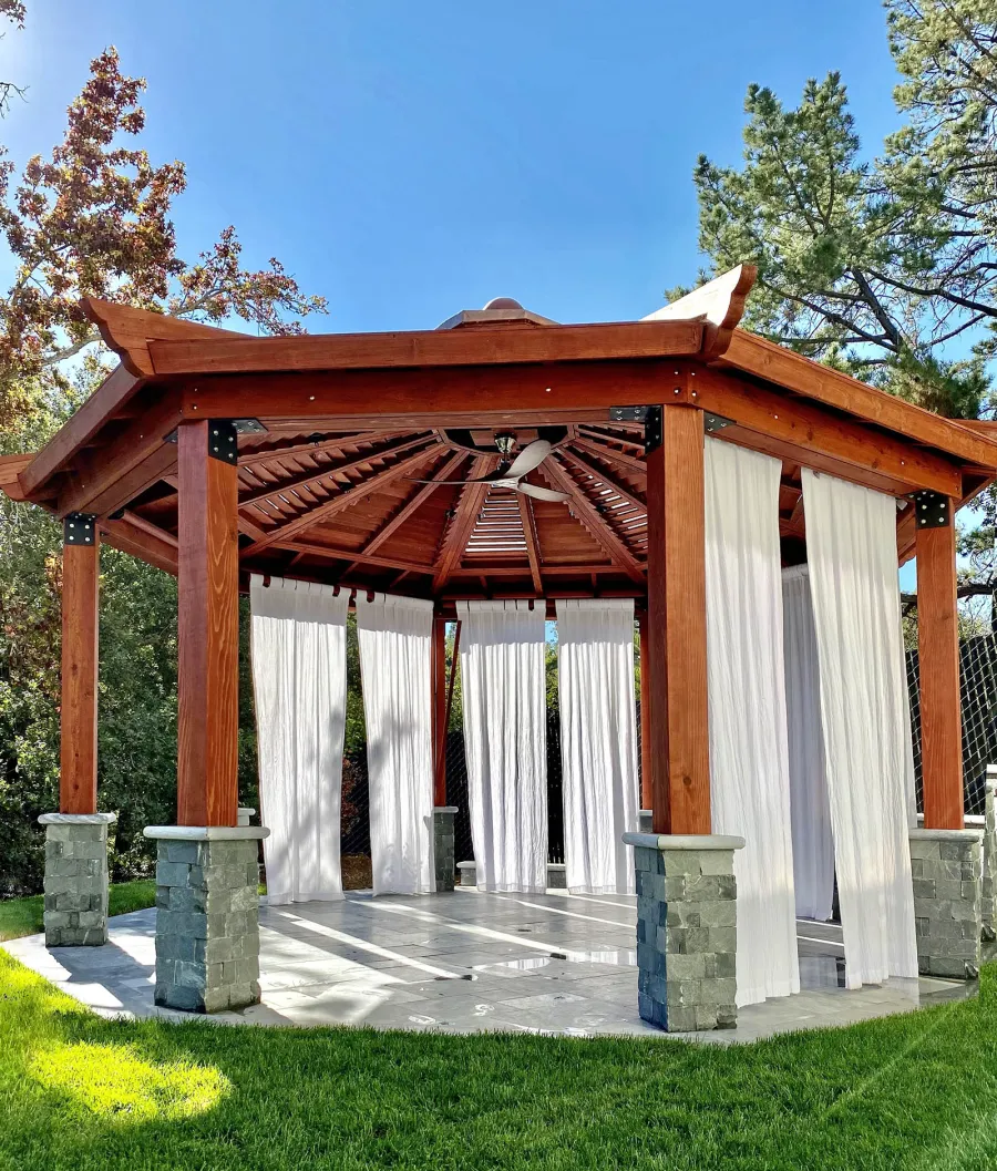 Custom Kikue's Pavilion (Options: 20' Diameter, Mature Redwood, with a Ceiling Fan Base, with Louvers and Rain Guard, Posts Anchor Kit for High-Wind, Transparent Premium Sealant). Photo Courtesy of C. Young of Los Gatos, CA.
