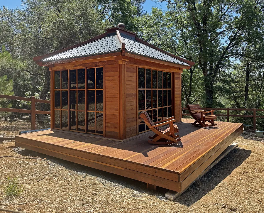 Custom Kikue's Tea House (Options: 14' x 12', 8' Wall Height, Metal Roof [Slate Gray, Metal Tile - Stile Style by bestbuymetals.com], California Redwood, with Solid Walls by Custom Request, Interior and External Decking, 6' Deck on the Front Side and 3' Decks on the Sides, Transparent Premium Sealant). Photo Also Shows 2 Ensenada Rocking Chairs. Photo Courtesy of A. Hagadron of Rough Ready, CA.