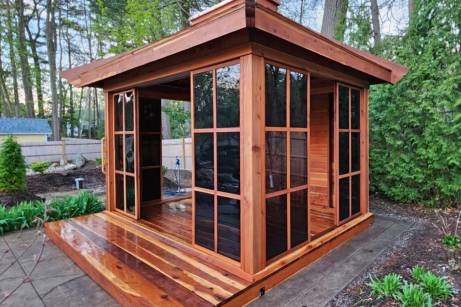 Kikue's Tea House (Options: 14 ft L x 10 ft W, 8' Wall Height, Wood Shingle Roof, California Redwood, 3 Sliding Walls and One Fixed Wood Wall, No Electrical Wiring Trim, with Wood Handle, Interior and External Decking, Transparent Premium Sealant). Photo Courtesy of A. Perry of Longmeadow, MA.