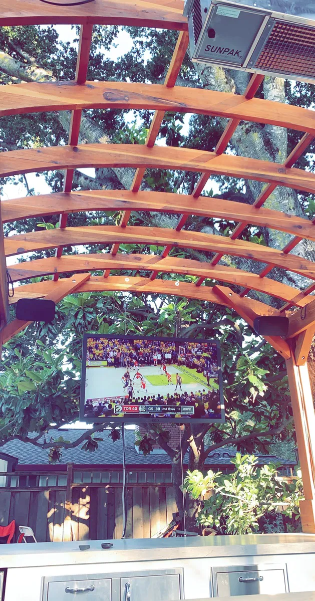 Marin Outdoor Kitchen Pergola (Options: 14' L x 14' Arc W, California Redwood, Unattached, 2 Post Electrical Wiring Trim, 4-Post Anchor Kit for Stone, No Ceiling Fan Base, No Privacy, No Curtain Rods, 9 ft Post Height (front posts wrapped with masonry), Transparent Premium Sealant). Photo Courtesy of C. Funkhouser of Hillsborough, California.