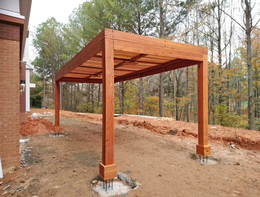 Modern Louvered Garden Pergola (Options: 22' L x 10' W, 8'' x 8'' Posts, Mobile Louvers, California Redwood, 9.5 ft H, No Electrical Wiring Trim, 4 Post Anchor Kit for High-Wind, No post decorative trims, No Ceiling Fan Base, Transparent Premium Sealant). The post anchors were placed above grade, so that the final hardscape can be poured over the footings so that there is no joint showing and the final hardscape will be seamless. Photo Courtesy of M. Graff of Atlanta, Georgia.