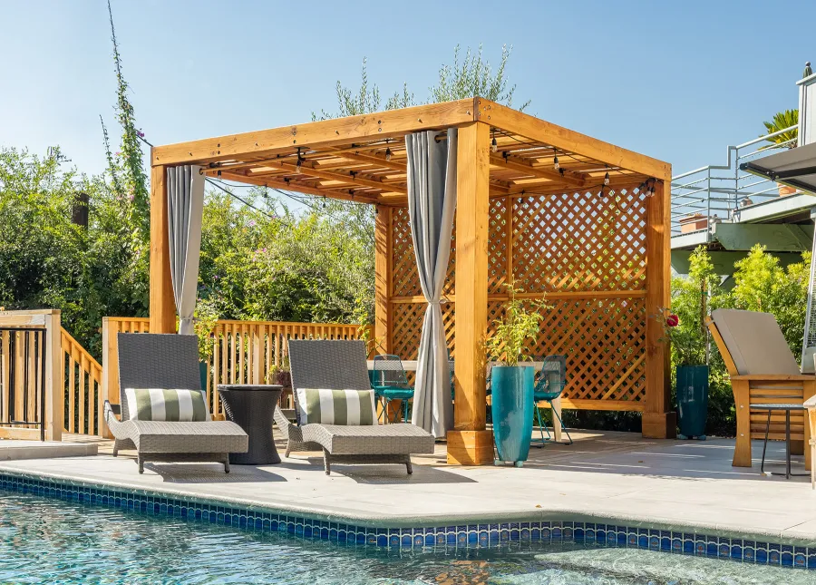 Modern Louvered Garden Pergola (Options: 12' L x 12' W, 8'' x 8'' Posts, Mobile Louvers, Douglas-fir, with 1 Lattice Privacy Wall, Electrical Wiring Trim for 1 Post, Without Fascia, No Curtain Rods, 4 Post Anchor Kit for Wood, No Post Decorative Trims, No Ceiling Fan Base, Transparent Premium Sealant). Photo Courtesy of S. Weinswig of Los Angeles, CA.