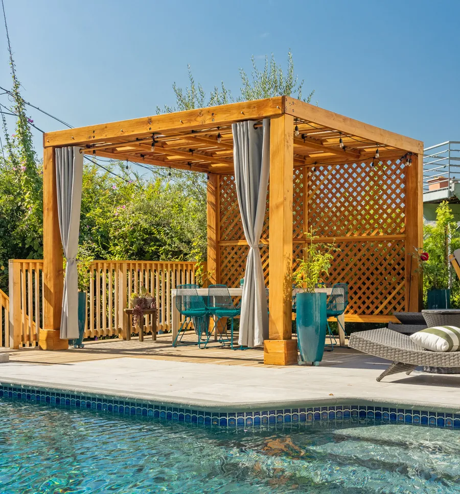 Modern Louvered Garden Pergola (Options: 12' L x 12' W, 8'' x 8'' Posts, Mobile Louvers, Douglas-fir, with 1 Lattice Privacy Wall, Electrical Wiring Trim for 1 Post, Without Fascia, No Curtain Rods, 4 Post Anchor Kit for Wood, No Post Decorative Trims, No Ceiling Fan Base, Transparent Premium Sealant). Photo Courtesy of S. Weinswig of Los Angeles, CA.
