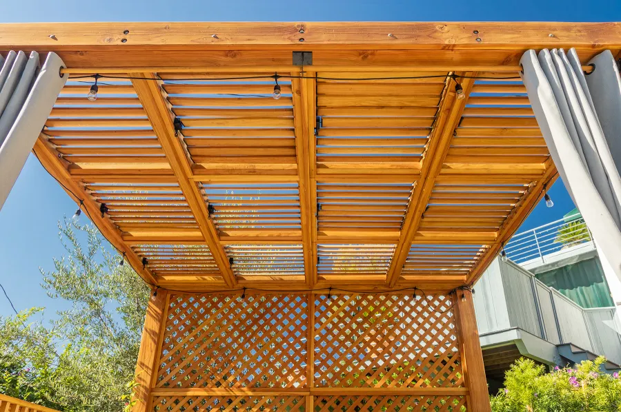 Modern Louvered Garden Pergola (Options: 12' L x 12' W, 8'' x 8'' Posts, Mobile Louvers, Douglas-fir, with 1 Lattice Privacy Wall, Electrical Wiring Trim for 1 Post, Without Fascia, No Curtain Rods, 4 Post Anchor Kit for Wood, No Post Decorative Trims, No Ceiling Fan Base, Transparent Premium Sealant). Photo Courtesy of S. Weinswig of Los Angeles, CA.