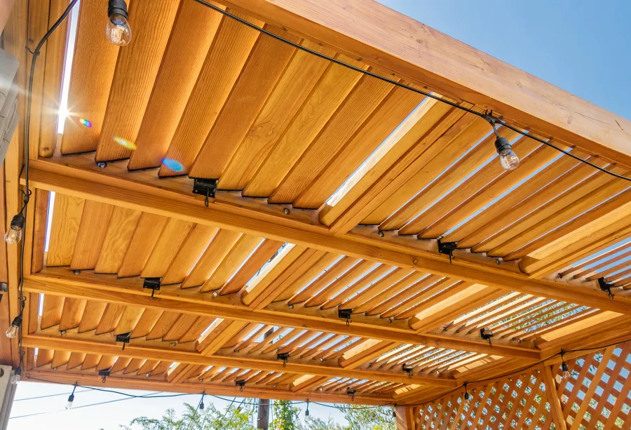 Modern Louvered Garden Pergola (Options: 12' L x 12' W, 8'' x 8'' Posts, Mobile Louvers, Douglas-fir, with 1 Lattice Privacy Wall, Electrical Wiring Trim for 1 Post, Without Fascia, No Curtain Rods, 4 Post Anchor Kit for Wood, No Post Decorative Trims, No Ceiling Fan Base, Transparent Premium Sealant). Photo Courtesy of S. Weinswig of Los Angeles, CA.