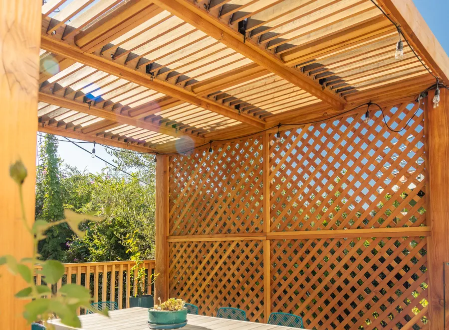 Modern Louvered Garden Pergola (Options: 12' L x 12' W, 8'' x 8'' Posts, Mobile Louvers, Douglas-fir, with 1 Lattice Privacy Wall, Electrical Wiring Trim for 1 Post, Without Fascia, No Curtain Rods, 4 Post Anchor Kit for Wood, No Post Decorative Trims, No Ceiling Fan Base, Transparent Premium Sealant). Photo Courtesy of S. Weinswig of Los Angeles, CA.