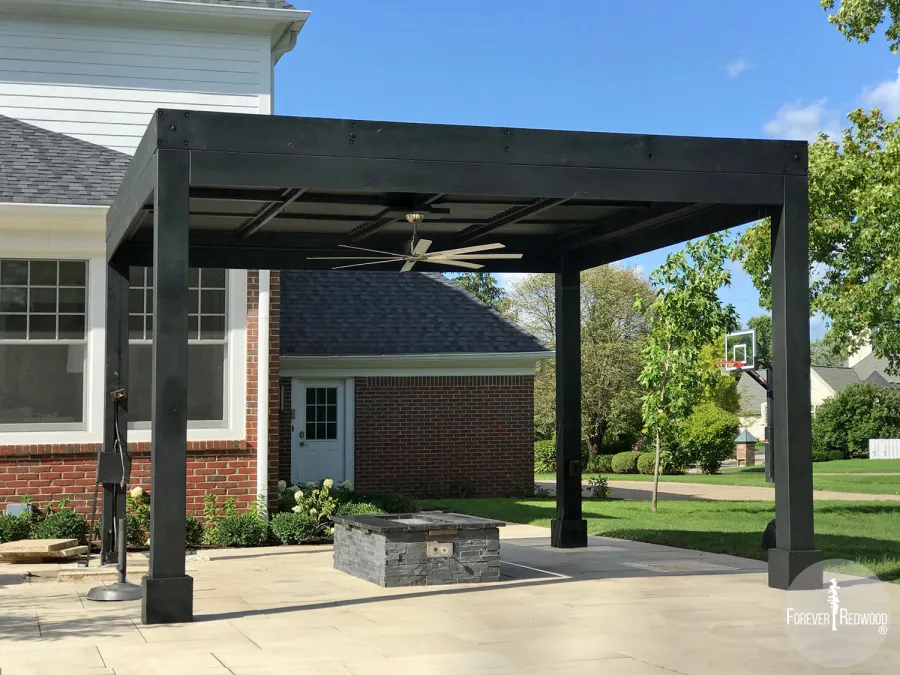 Modern Louvered Garden Pergola (Options: 14' L x 14' W, 8'' x 8'' Posts, Mobile Louvers, California Redwood, 10 ft H, 2 Electrical Wiring Trims, No Curtain Rods, 4 Post Anchor Kit for Concrete, No Post Decorative Trims, 1 Ceiling Fan Base, Custom Black Stain). Photo Courtesy of B. Amiano of Carmel, Indiana.