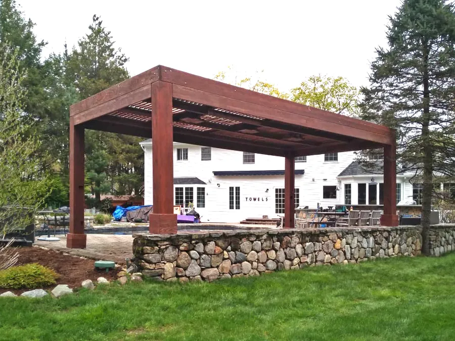 Modern Louvered Garden Pergola (Options: 24' L x 12' W, 10'' x 10'' Posts, Mobile Louvers, California Redwood, 10 ft H [2 Posts Shorter Seating Atop the Pony Wall], No Electrical Wiring Trim, 4 Curtain Rods, 4 Post Anchor Kit for Concrete, No Post Decorative Trims, 2 Ceiling Fan Bases, Coffee-Stain Premium Sealant). Photo Courtesy of J. VanderKamp of Westport, Connecticut.