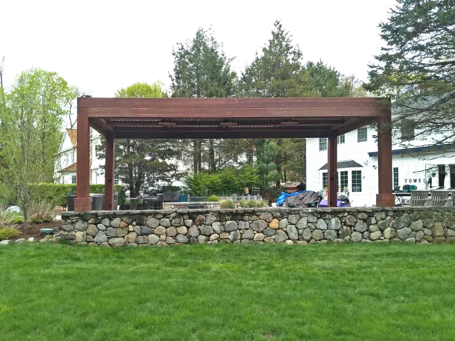 Modern Louvered Garden Pergola (Options: 24' L x 12' W, 10'' x 10'' Posts, Mobile Louvers, California Redwood, 10 ft H [2 Posts Shorter Seating Atop the Pony Wall], No Electrical Wiring Trim, 4 Curtain Rods, 4 Post Anchor Kit for Concrete, No Post Decorative Trims, 2 Ceiling Fan Bases, Coffee-Stain Premium Sealant). Photo Courtesy of J. VanderKamp of Westport, Connecticut.