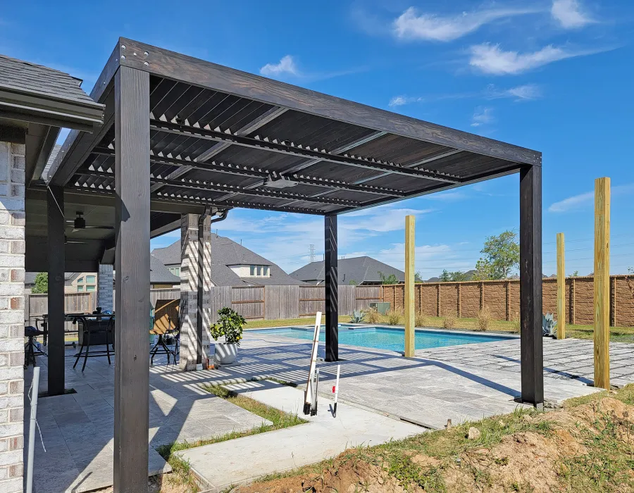 Modern Louvered Garden Pergola (Options: 16' L x 14'-6'' W, 8'' x 8'' Posts, Mobile Louvers, Douglas-fir, Electrical Wiring Trim for 1 Post, Without Fascia, No Curtain Rods, 4 Post Anchor Kit for Concrete, No Post Decorative Trims, 1 Ceiling Fan Base, Black Stain Premium Sealant). Photo Courtesy of J. Roan of Katy, TX.