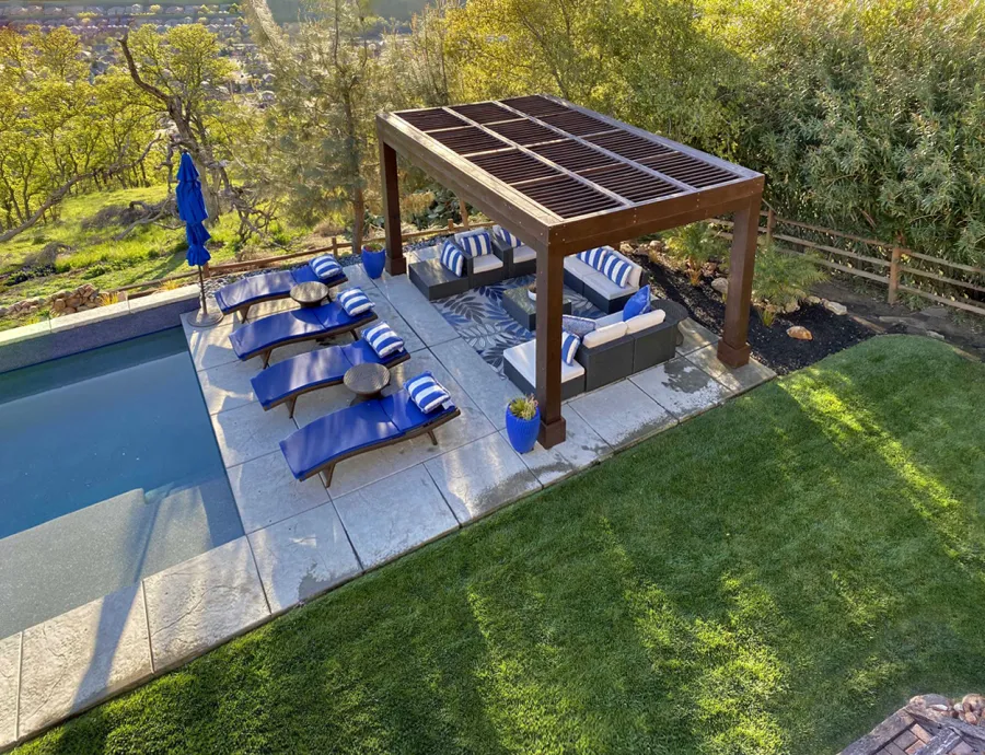 Modern Louvered Garden Pergola (Options: 16' L x 12' W, 10'' x 10'', Fixed Louvers, Douglas-fir, 9.5 ft H, No Electrical Wiring Trim Kit, 4 Post Anchor Kit for Concrete, No Post Decorative Trims, No Ceiling Fan Base, 4 Curtain Rods, Coffee Stain Sealant). Photo Courtesy of R. McCan of El Dorado Hills, CA