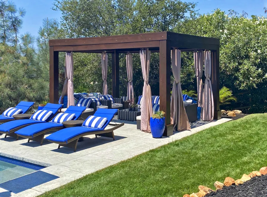 Modern Louvered Garden Pergola (Options: 16' L x 12' W, 10'' x 10'', Fixed Louvers, Douglas-fir, 9.5 ft H, No Electrical Wiring Trim Kit, 4 Post Anchor Kit for Concrete, No Post Decorative Trims, No Ceiling Fan Base, 4 Curtain Rods, Coffee Stain Sealant). Photo Courtesy of R. McCan of El Dorado Hills, CA