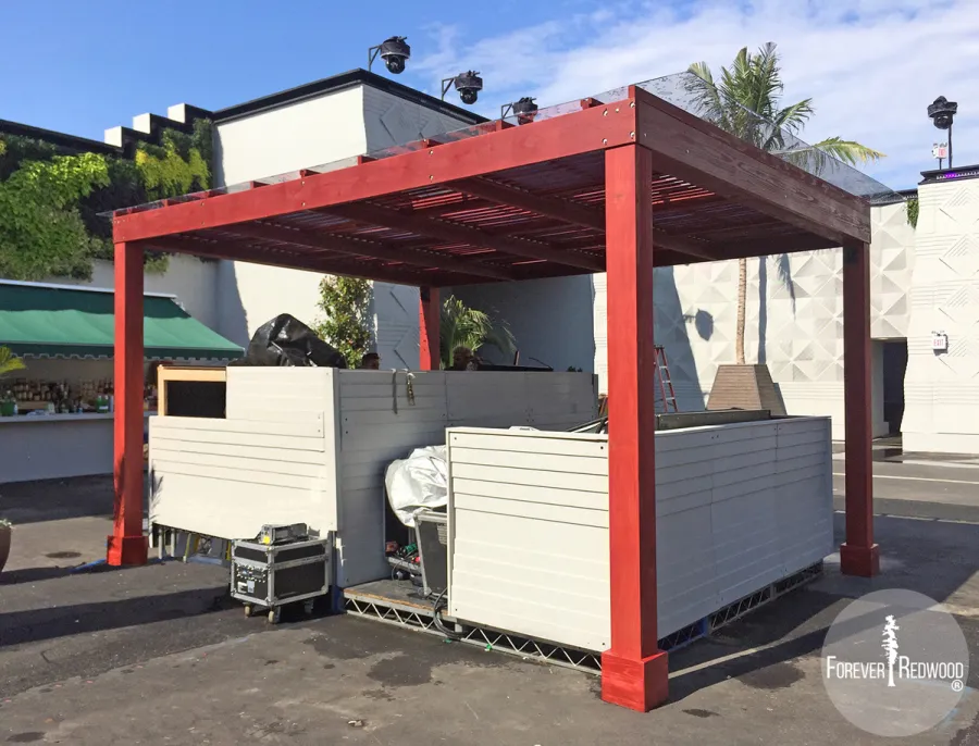 Modern Louvered Garden Pergola (Options: 14' L x 18' W, 6'' x 6'' Posts by Custom Request, Mobile Louvers, California Redwood, 10ft H, Electrical Wiring Trim for 1 Post, 4 Post Anchor Kit for Concrete, No post decorative trims, Add a Ceiling Fan Base, 2 Curtain Rods, Cherry Stain Premium Sealant). Photo taken by our install crews while site still in flux. Photo included her to highlight custom designed framed polycarbonate panels added as a top roof layer to make the Modern Louvered Pergola also waterproof. Photo Courtesy of Dizon of Brooklyn, NY.