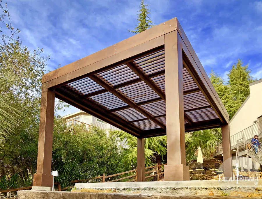 Modern Louvered Garden Pergola (Options: 16' L x 12' W, 10'' x 10'', Fixed Louvers, Douglas-fir, 9.5 ft H, No Electrical Wiring Trim Kit, 4 Post Anchor Kit for Concrete, No Post Decorative Trims, No Ceiling Fan Base, 4 Curtain Rods, Coffee Stain Sealant). Photo Courtesy of R. McCan of El Dorado Hills, CA