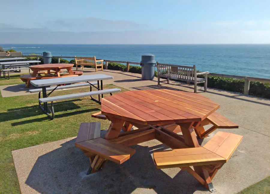 Octagonal Picnic Tables (Options: 5 1/2' Diameter Tabletop, Attached Benches, California Redwood, Standard Tabletop, 1 5/8" Umbrella Hole, Transparent Premium Sealant). Photo Courtesy of G. Cooley of Dana Point, CA. Plastic gray tables not made by Forever Redwood!