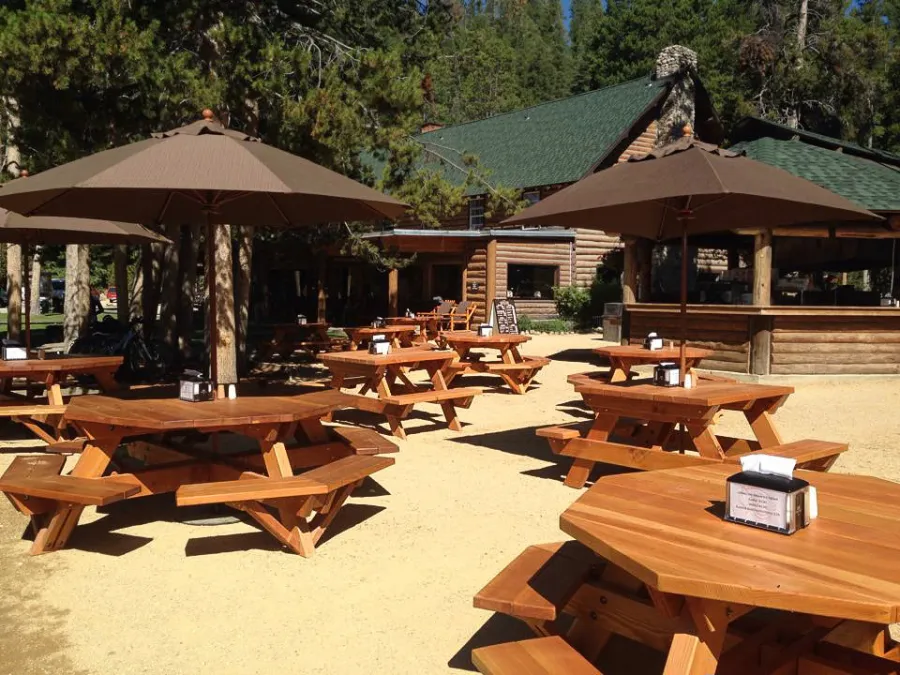 Octagonal Picnic Tables (Options: 6' Diameter Tabletop, Attached Benches, Douglas-fir, Standard Tabletop, Rounded Corners, Umbrella Hole, Transparent Premium Sealant). Forever Picnic Tables Shown in Background.  Photo Courtesy of Jeff C. of Stanley, Idaho.
