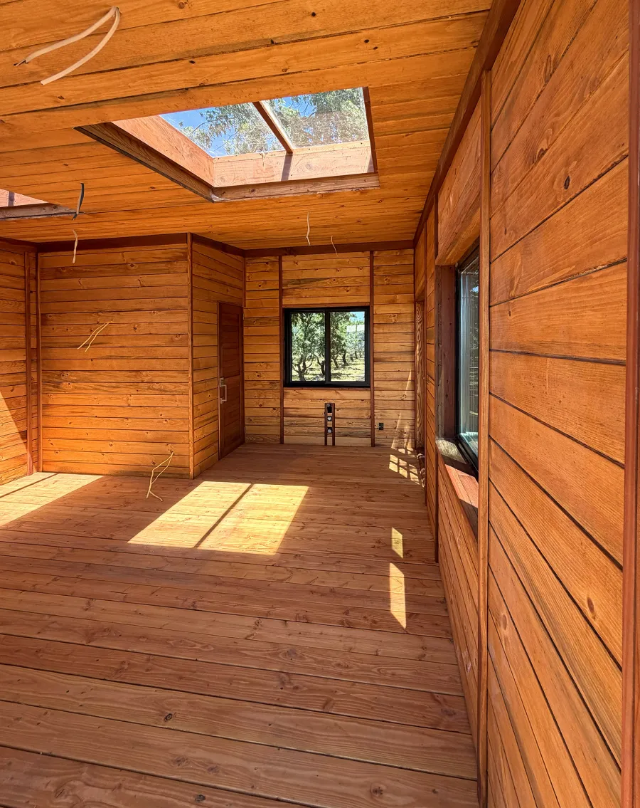 Custom Palo Alto Backyard Cabin (Options: 18' L, 16' W, With 19' x 19' Structural Deck with Steps, California Redwood for Exterior Finished, Douglas-fir Internal Walls and Framing, Double Door, Slidding Windows, Windows Purchased Locally, With Two 2' x 2' Skylights, Metal Roof, Electrical Wire Trim on the Walls, Transparent Premium Sealant). Photo Courtesy of R. and M. Hegwood of Ceres, CA.