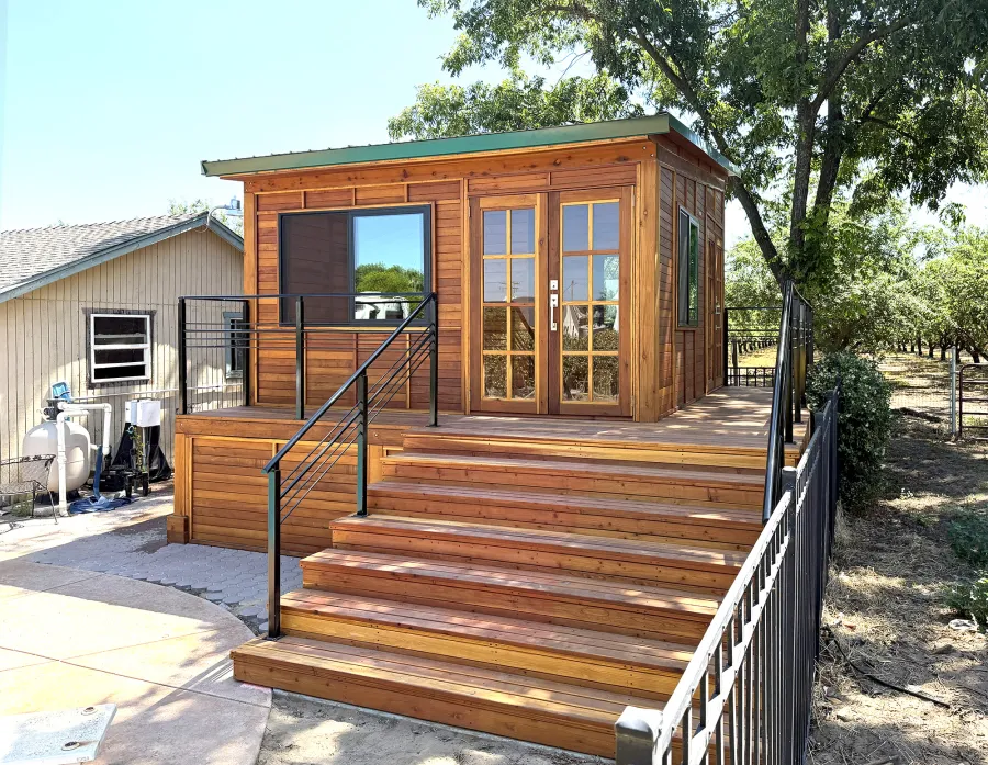 Custom Palo Alto Backyard Cabin (Options: 18' L, 16' W, With 19' x 19' Structural Deck with Steps, California Redwood for Exterior Finished, Douglas-fir Internal Walls and Framing, Double Door, Slidding Windows, Windows Purchased Locally, With Two 2' x 2' Skylights, Metal Roof, Electrical Wire Trim on the Walls, Transparent Premium Sealant). Photo Courtesy of R. and M. Hegwood of Ceres, CA.
