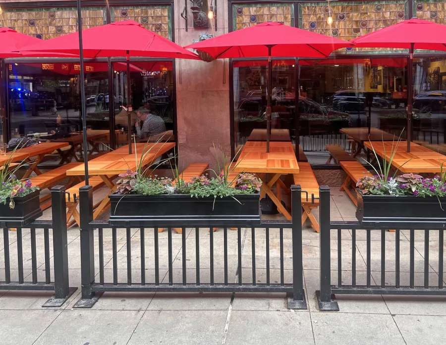 Rectangular Folding Picnic Tables (Options: 7' L x 30'' W, Folding Side Benches, Mosaic Douglas-Fir,  1 Full Length Bench/Side, Seamless Tabletop, Checkerboard Design Tabletop, 2'' Umbrella Hole,  Transparent Premium Sealant). Tables Installed in Elephant and Castle Restaurant, 185 N Wabash Ave, Chicago, IL 60601.