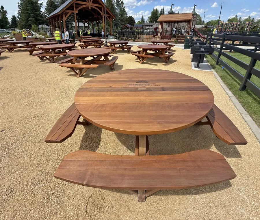 Round Wooden Picnic Tables (Attached Benches) (Options: 6' Diameter, Mature Redwood, Custom Engraving, Transparent Premium Sealant). Installed in Faith Walk Community Fitness Park in Coeur d'Alene, Idaho.
