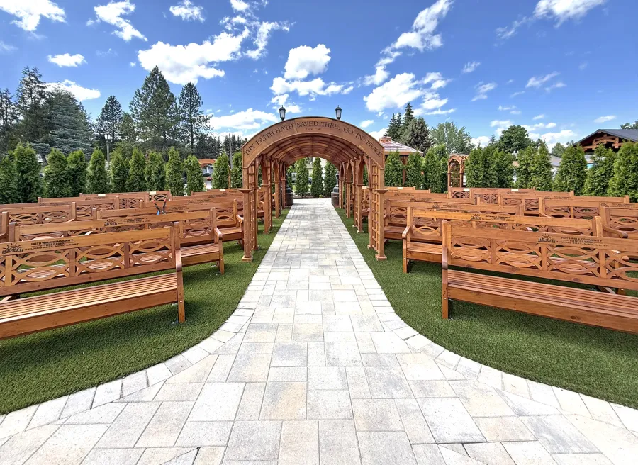 Victorian Trellis (Options: 22' x 8', California Redwood, Custom Engraving, Transparent Premium Sealant). Photo Also Shows Several Hennell Garden Benches. Trellis Installed in Faith Walk Community Fitness Park in Coeur d'Alene, Idaho.