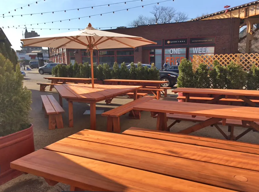 Custom Forever Picnic Tables (Unattached Benches) (Options: 10' L, 34 ½in W, Old-Growth, 2 Full Length Side Benches, Standard Tabletop, Squared Corners, 2 ½in Umbrella Hole, Standard Leg Flair, Transparent Premium). Using Two Tongue & Groove Matching 5 3/4" Boards to Create the Appearance of an 11 1/2" Wide Board Construction. Photo Also Shows a Custom Triangular Picnic Table Set. Photo courtesy of Small Cheval Restaurant, 1732 N Milwaukee Ave, Chicago, IL 60647.