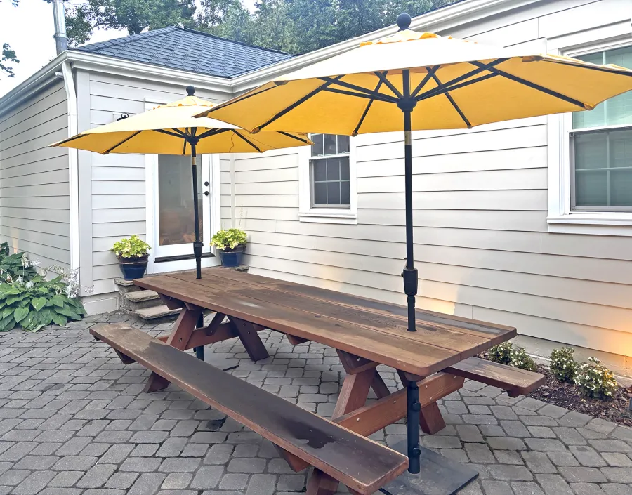 Heritage Large Wooden Picnic Table (Options: 10' L, 34 1/2" W, Side Benches, Attached Benches, Standard Tabletop, Rounded Corners, 2 Umbrella Holes of 2", Transparent Premium Sealant). Photo Taken 1 Year After Installation. Photo Courtesy of M. Nelson of Greensboro, NC.