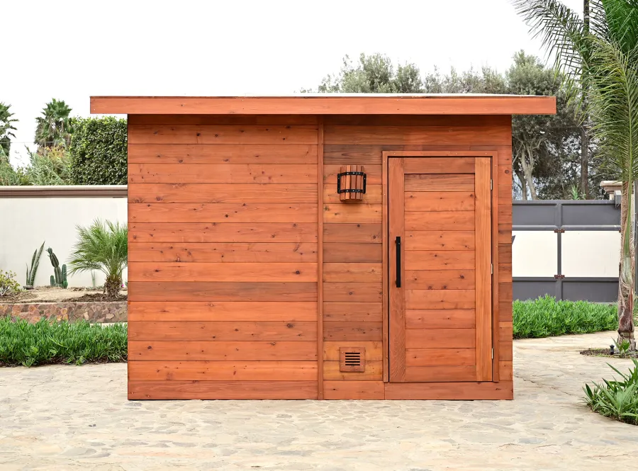 Raul’s Rad Redwood Sauna (Options: 11' W, 8' D, 11' H, California Redwood (for Interiors) & Mature Redwood (for Exteriors), Pitch Roof for Exterior Areas, "L" Shape Bench (2 levels), Transparent Premium Sealant).