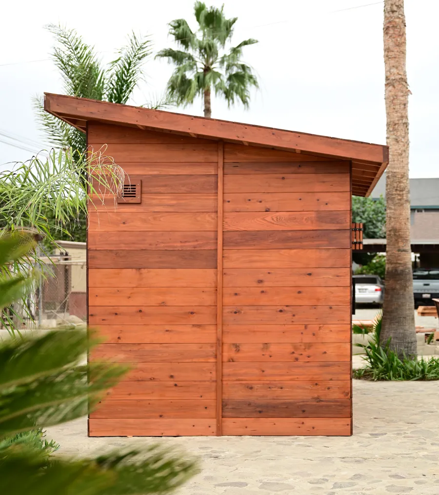 Raul’s Rad Redwood Sauna (Options: 11' W, 8' D, 11' H, California Redwood (for Interiors) & Mature Redwood (for Exteriors), Pitch Roof for Exterior Areas, "L" Shape Bench (2 levels), Transparent Premium Sealant).