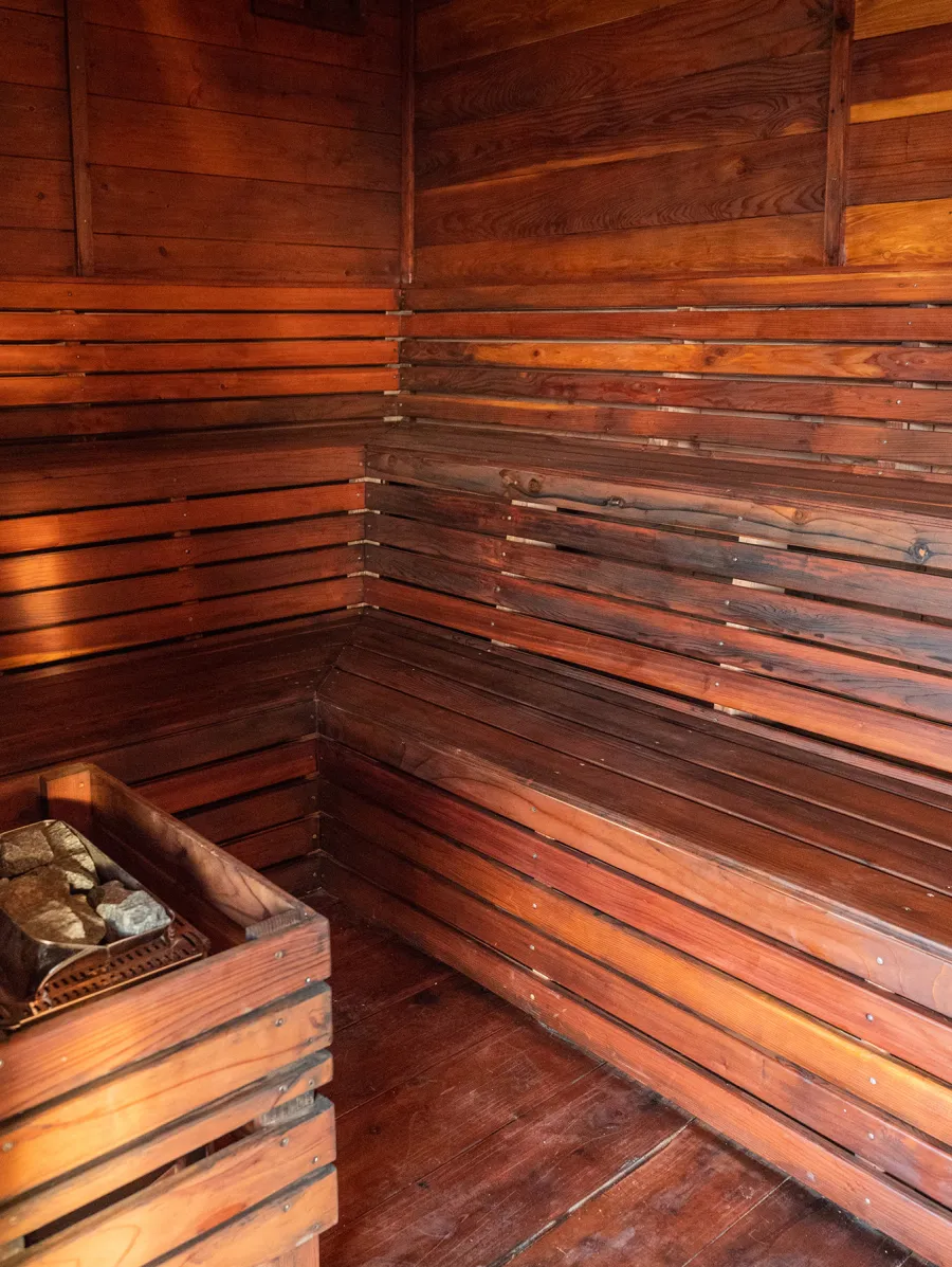 Raul’s Rad Redwood Sauna (Options: 11' W, 8' D, 11' H, California Redwood (for Interiors) & Mature Redwood (for Exteriors), Pitch Roof for Exterior Areas, "L" Shape Bench (2 levels), Transparent Premium Sealant).