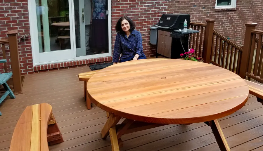 Round Wood Picnic Table with Wheels (Options: 5' diameter, Unattached Benches, Redwood, Round Picnic Benches, Standard Tabletop, No Lazy Susan, 1 5/8" Umbrella Hole & Plug, Transparent Premium Sealant). Photo Courtesy of A. Adler of Hempstead, New York.