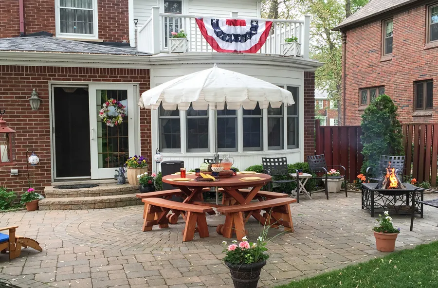 Round Wood Picnic Table with Wheels (Options: 5.5' Diameter, Unattached Benches, Mature Redwood, Round Picnic Benches, Standard Tabletop, 20" Lazy Susan, Umbrella Hole & Plug, Transparent Premium Sealant). Photo Courtesy of Dorothy and Sam Cusmano of Grosse Pointe Park, Michigan.