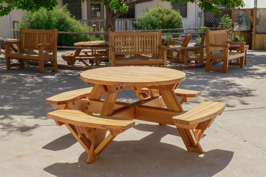 Round Wooden Picnic Table (Attached Benches) (Options: 4' Diameter, Attached Benches, Mosaic Douglas-Fir, Standard Tabletop, No Lazy Susan, No Umbrella Hole, Transparent Premium Sealant). Photo courtesy of Vanguard University [55 Fair Dr, Costa Mesa, CA].